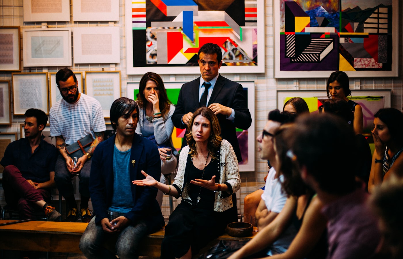 A panel discussion in front of the print wall