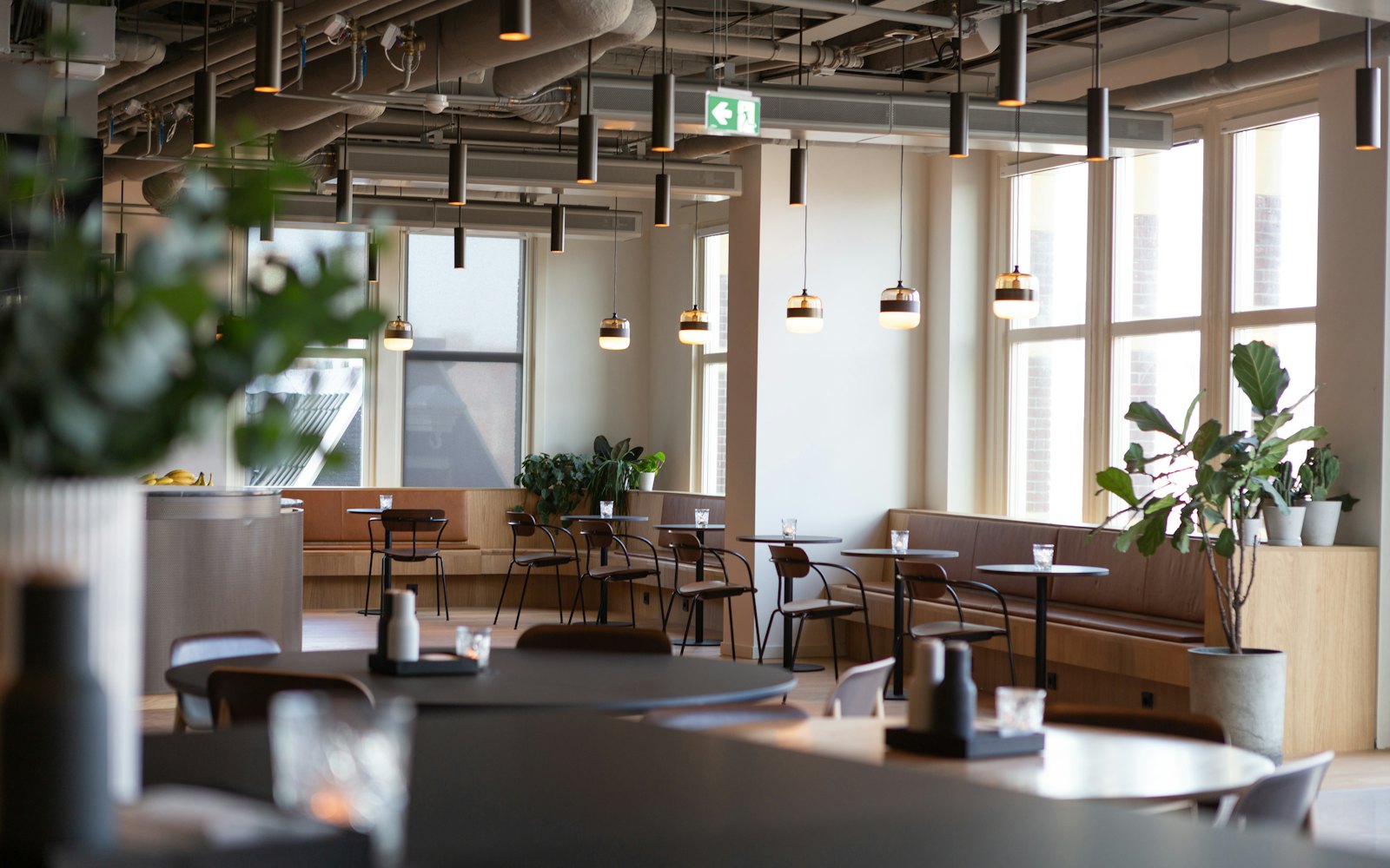 The Meridian Lisbon lounge, with banquette seating, pendant lighting and tall street windows