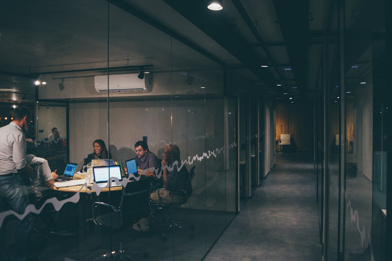 The glazed meeting rooms along the light well at Meridian Singapore