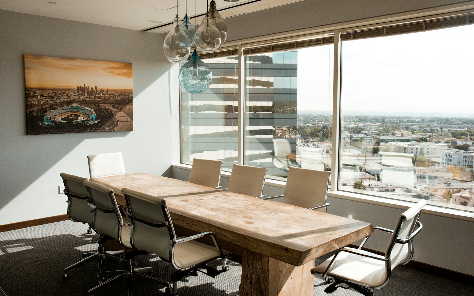 The Singapore boardroom, with a solid timber table and the city beyond the glass