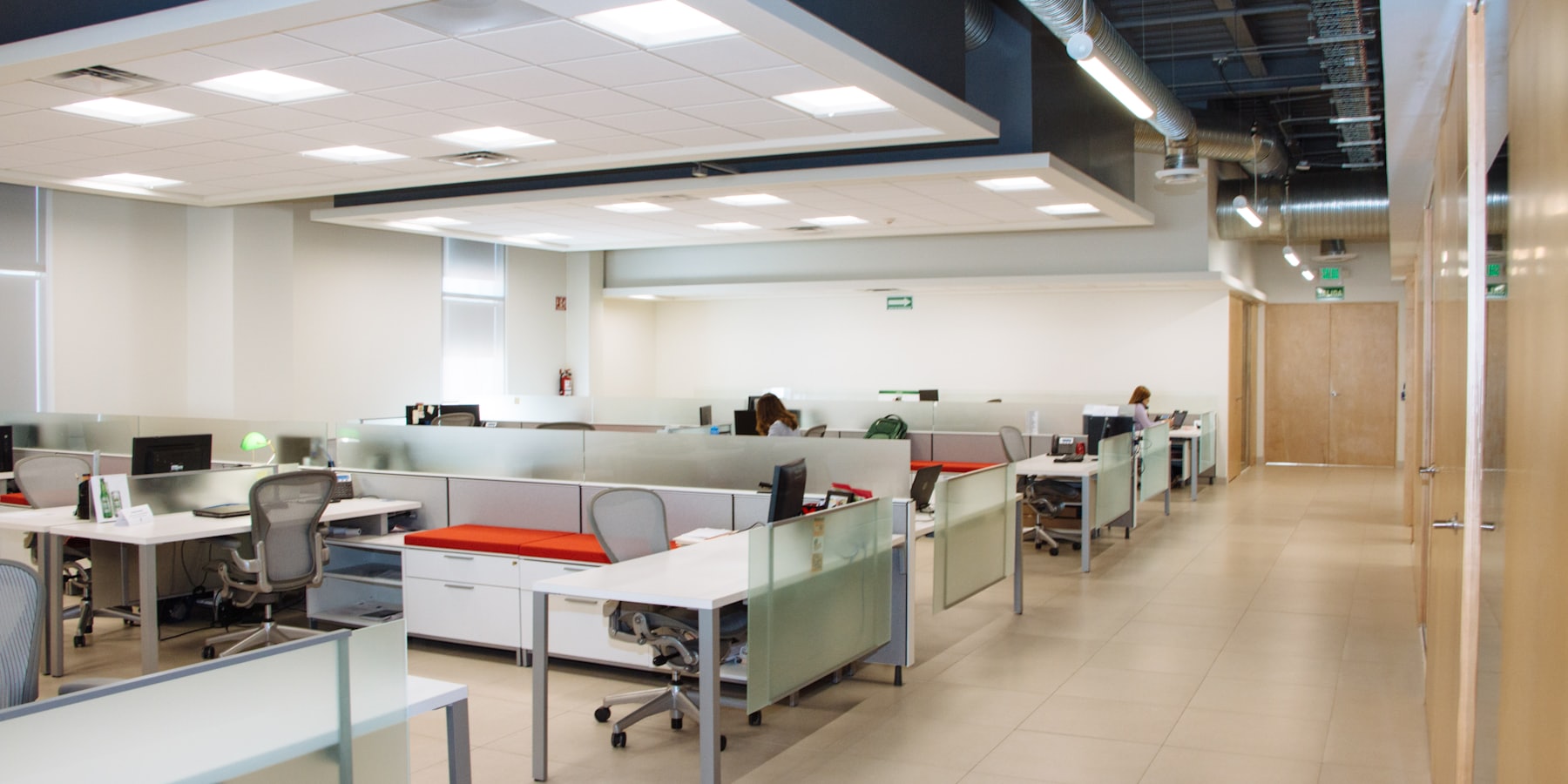 A private suite floor, with fitted desks, task chairs and full-height glazing